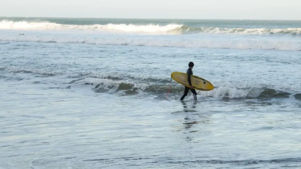 Surfer catching a wave in Taghazout, Morocco