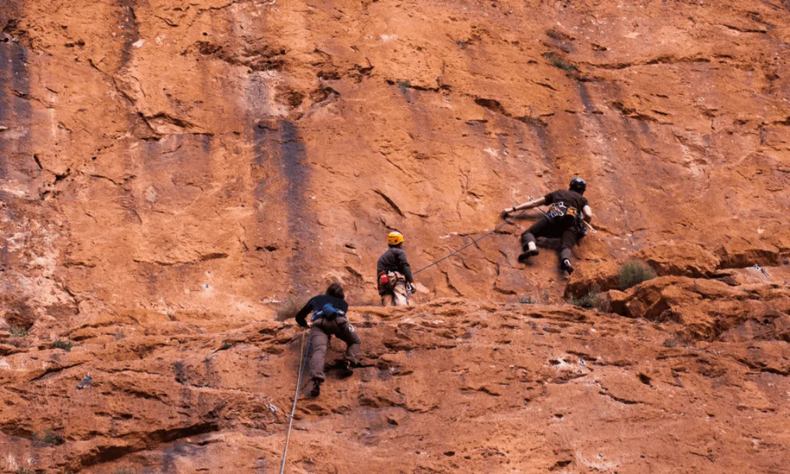 Climber scaling a limestone wall in Todra Gorge, Morocco