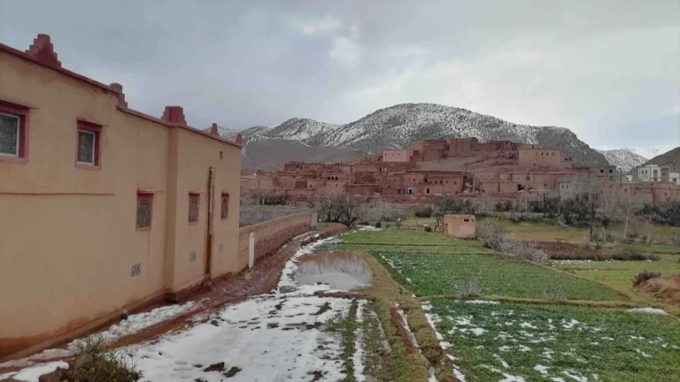 Berber village in the Atlas Mountains in winter, with snow on the hills and fields
