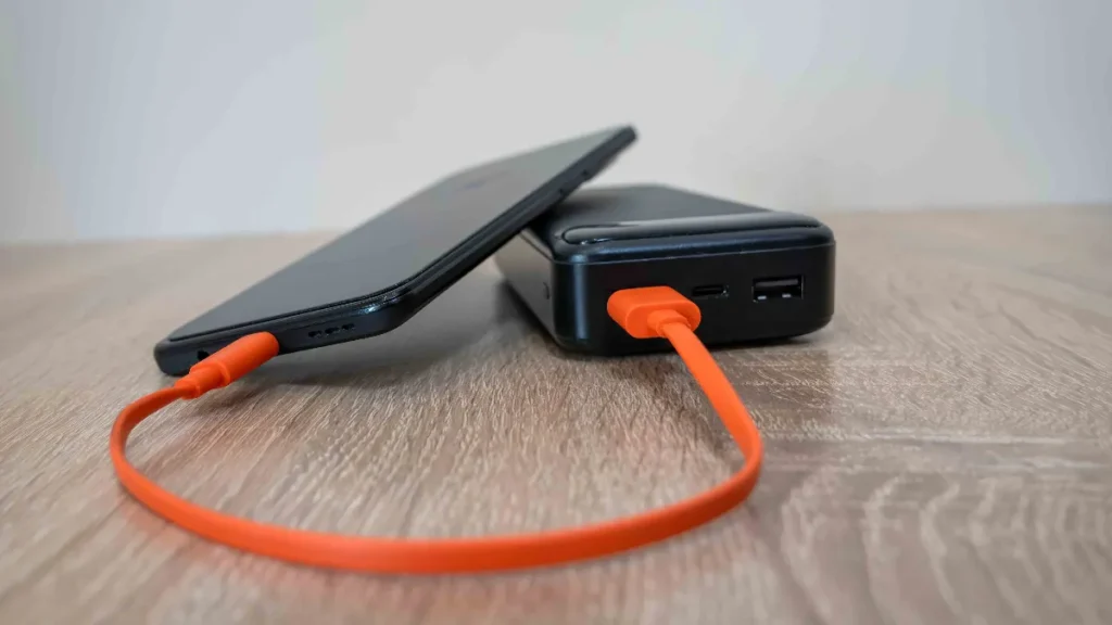 Power bank charging a phone while travelling