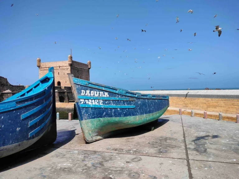Blue fishing boats in Essaouira port- One Day trip to Essaouira From Marrakech